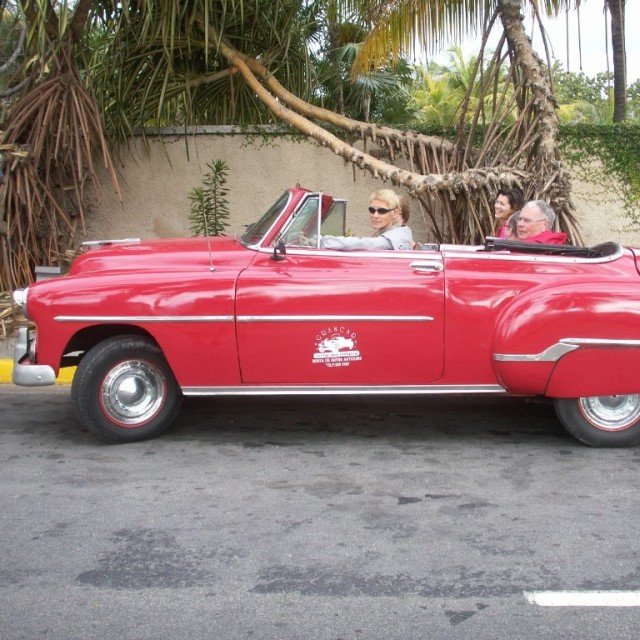 Red old school convertible on Cuban street
